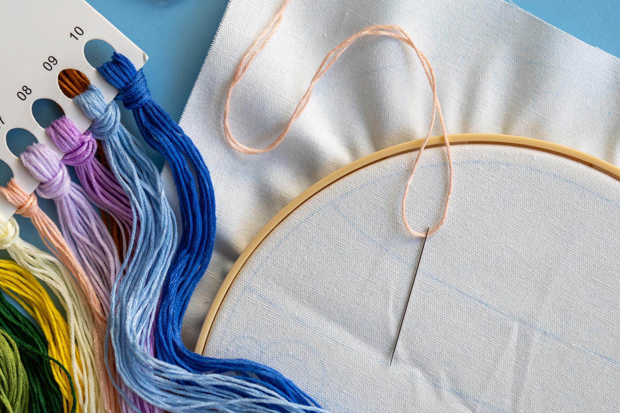 multiple embroidered garment samples laid out